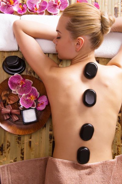 beautiful-woman-relaxing-spa-salon-with-hot-stones-body-beauty-treatment-therapy